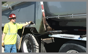 Image of a forklift and a driver getting pipes from a semi.